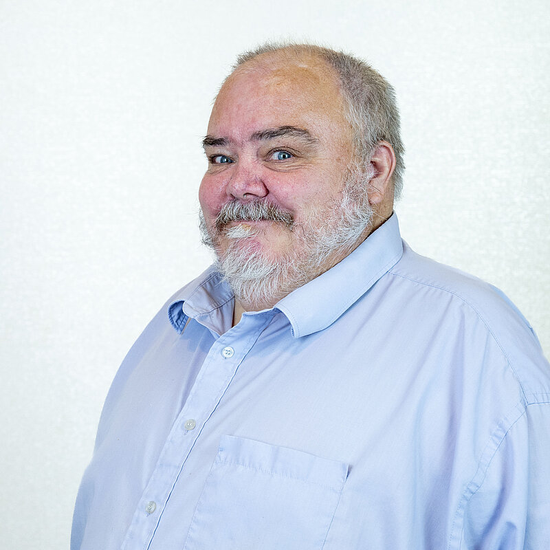 Jimmy Speirs smiling in a blue shirt